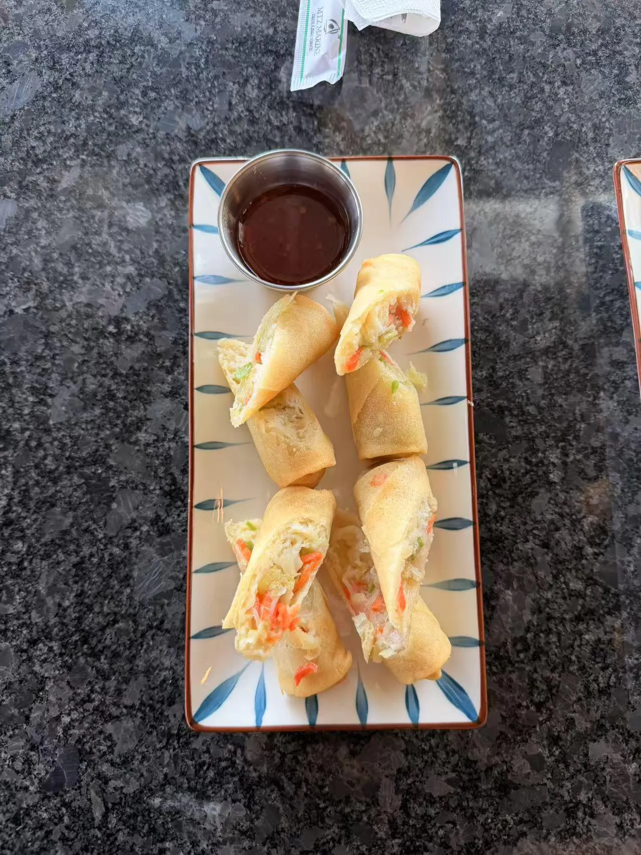 Crispy vegetable spring rolls with dipping sauce at Bobo Noodles And Dumplings, a Chinese Restaurant in Omaha