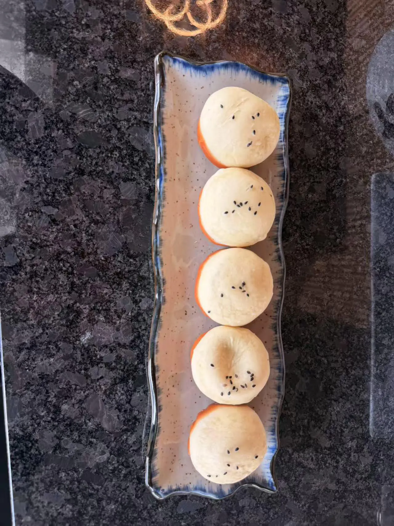 Baked buns with black sesame seeds at Bobo Noodles And Dumplings, a Chinese Restaurant in Omaha