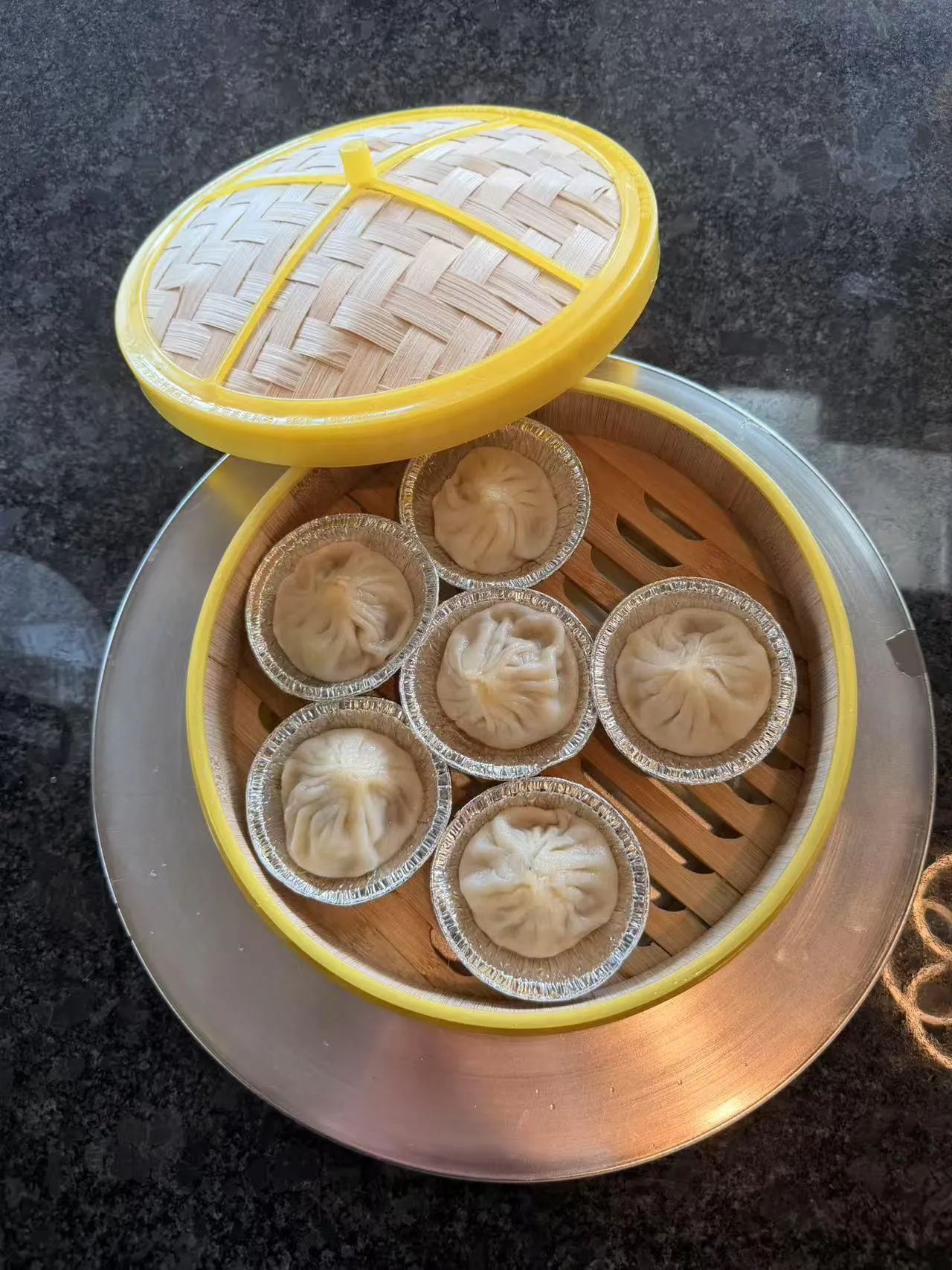 Steamed soup dumplings in bamboo steamer at Bobo Noodles And Dumplings, a Chinese Restaurant in Omaha