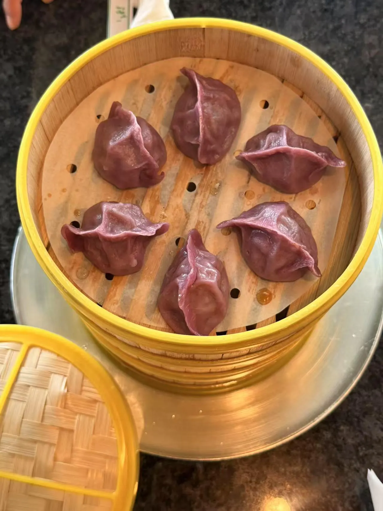 Steamed purple dumplings in bamboo steamer at Bobo Noodles And Dumplings, a Chinese Restaurant in Omaha
